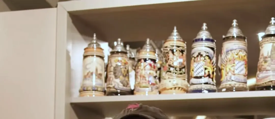 Regal mit bemalten Steinkrügen und Bierkrügen als Mitbringsl